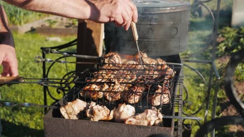 Roasting Fresh Juicy Meat in Burning Charcoals Fire in Barbecue Grill Basket