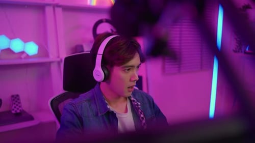 Young Adult Gamer in Colorful Room