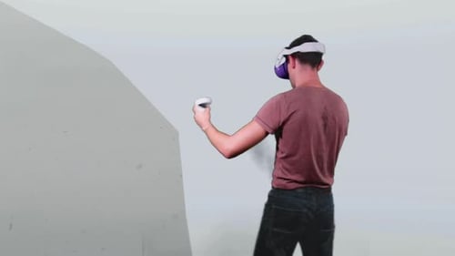 Man Playing Virtual Reality Shooting Game With VR Headset