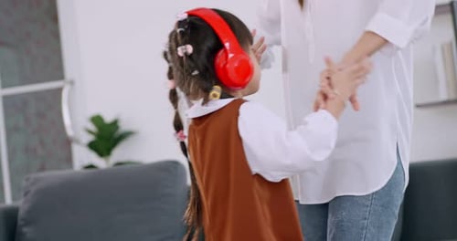 Mother and Daughter Dancing Together at Home