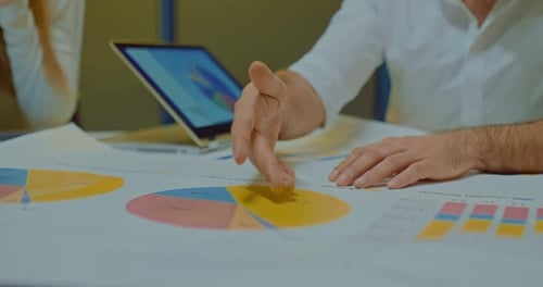 Director's male hand shows chart indicators, company profit increase segments.