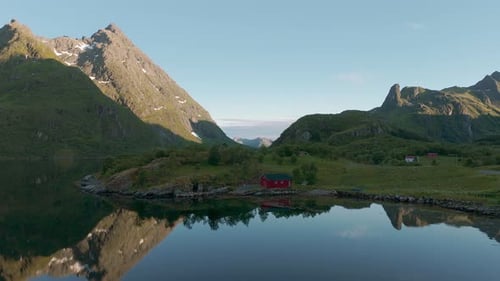 Idyllic red house. Lofoten island, Norway. Scandinavia nature with sea, fjord, mountain and water re