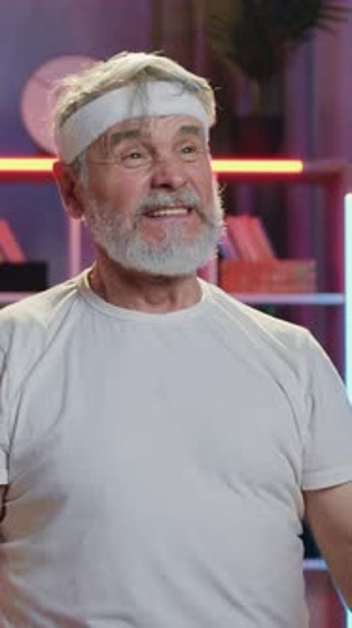 Smiling Senior Man Exercising with Dumbbell Indoors