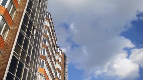 New Block of Modern Apartments with Balconies and Blue Sky in the Background
