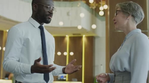 Multiethnic Colleagues Shaking Hands and Speaking