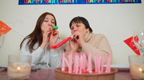 Women Celebrating Birthday With Noisemakers