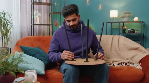 Man Assembling Furniture Table at Home