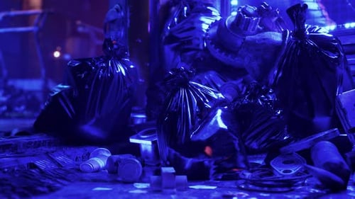 A Towering Heap of Discarded Waste Illuminated By Neon Lights on a Night Street