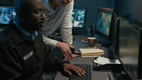 Woman Coordinating Security Operation in Control Room at Night