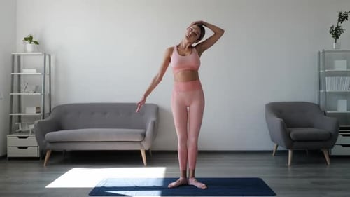 Woman Doing Yoga and Stretching in Home Interior
