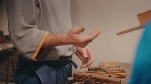Craftsman Carefully Assembling Wooden Box in Workshop