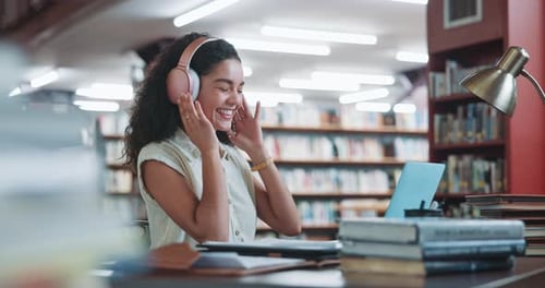 Woman, college student and headphones with dancing at library, books or happy for scholarship