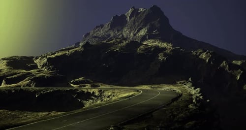 Winding Road Leads to a Towering Mountain in Twilight Light