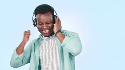 Music, headphones and black man in studio dance for streaming song, radio and audio