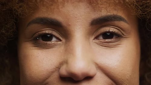 Smiling Curly Woman Eyes Extreme Close Up