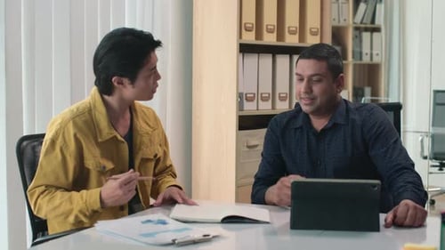 Business Meeting at Office with Chart and Tablet