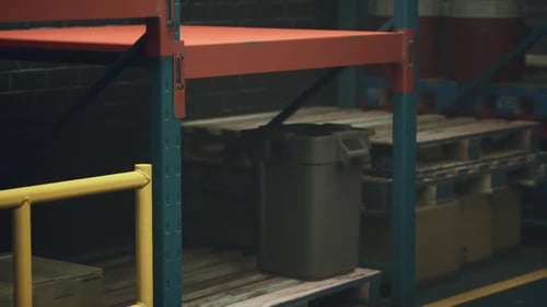 Storage Area With Red Shelf and Black Trash Can