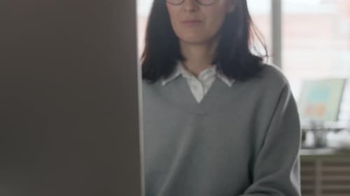 Young Female Employee Working on PC in Open Space Office