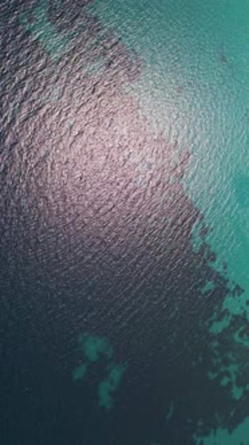 Closeup Aerial View of Crystalclear Turquoise Sea Water with Visible Textures and Gentle Ripples