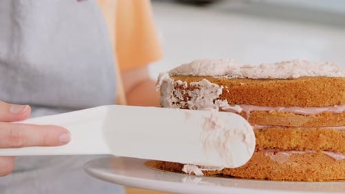 Icing delicious layer cake with yummy pink frosting