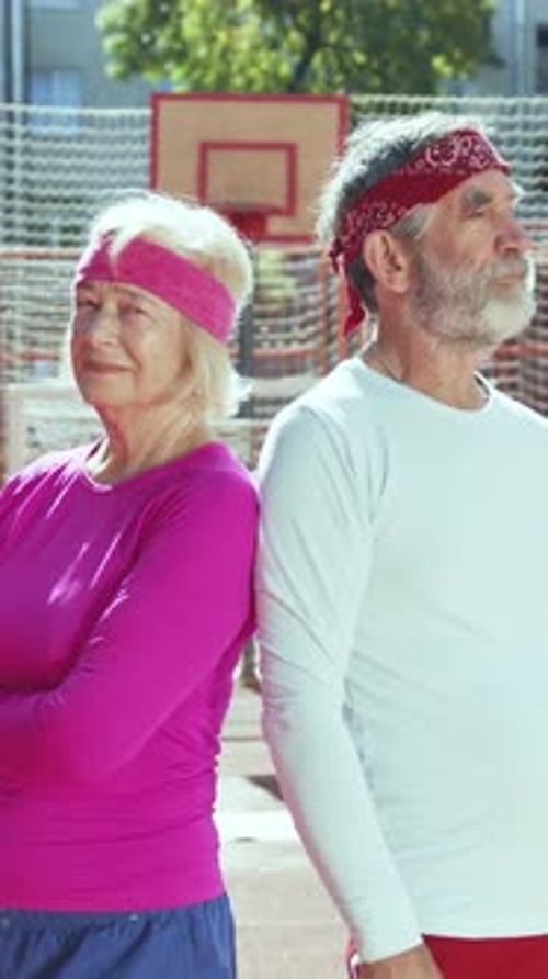 Active Senior Couple Smiling on Basketball Court
