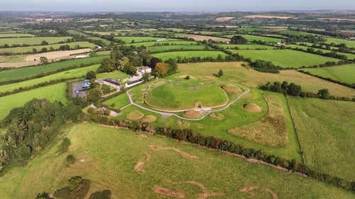 Aerial pull back from passage tomb entrance of Knowth megalithic monument, Ireland history.