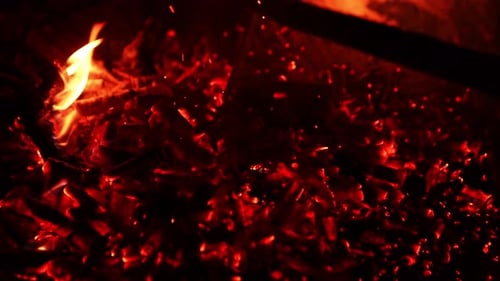 Red fire heat concept. Dark wood fireplace slow motion.
