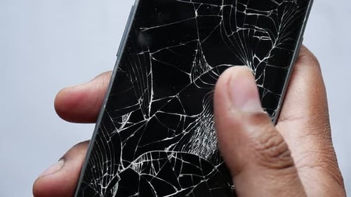 Close Up of Man Hand Holding Broken Smart Phone on White Background