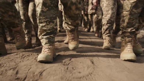Soldiers Marching in Camouflage on Dirt Road