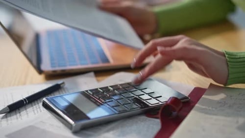 Calculator, Laptop and Financial Paperwork Close Up