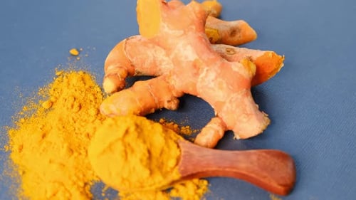 Turmeric Powder and Roots Curcuma Longa Kurkuma Panning Turmeric on Black Background Top View Close