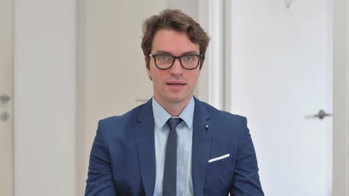 Portrait of Young Businessman with Inviting Gesture by