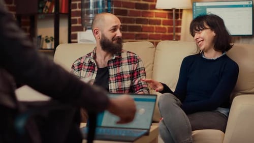 Couple Talking to Therapist on Couch in Home