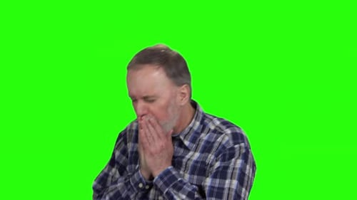 Man Coughing into Hands on Green Screen