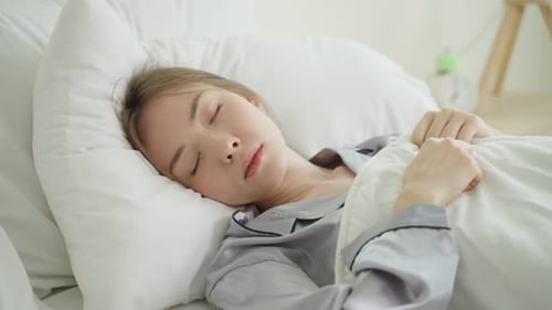 Woman Sleeping Soundly in Bed in the Daytime