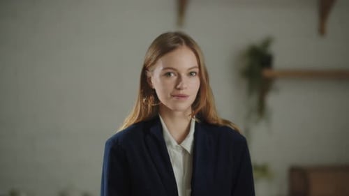 Beautiful Girl in Jacket Looking to Camera with Gently Smile Indoor Footage of a Pretty Young Woman