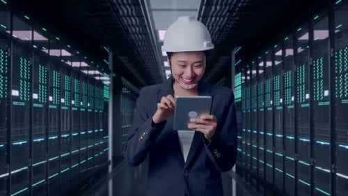 Asian Businesswoman Use Tablet While Walking in Data Center