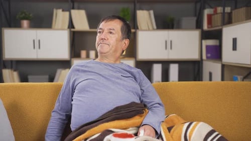 Man Sits on Couch in Living Space
