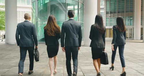 Business Professionals Walking Toward Office Building