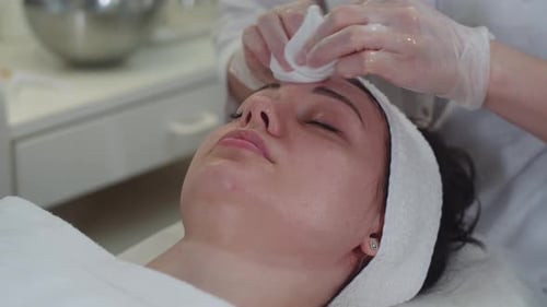 Woman Receives Facial Cleansing Treatment at Medical Spa