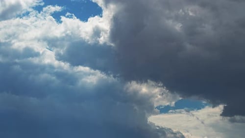 Large, fluffy clouds forming and disbursing in this dramatic time lapse cloudscape