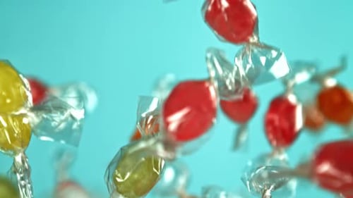 Colorful Wrapped Candies Floating on Blue Background