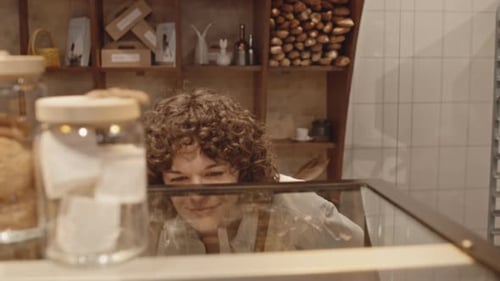 Customer Looking at Window Display in Patisserie Shop