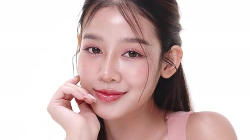 Close up portrait beautiful young Asian woman with healthy facial skin over white background.