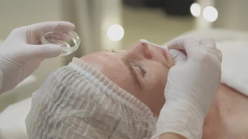 Woman Receives Gentle Facial Treatment in Clinic