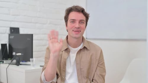 Portrait of Welcoming Young Creative Man Waving Hand