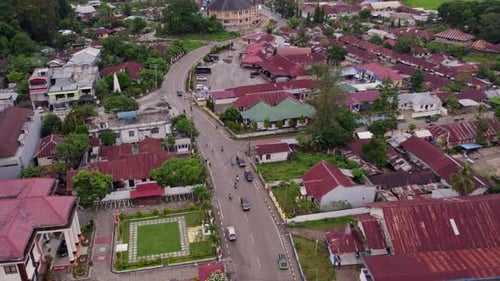 Aerial view of traditional village with church and city traffic, Indonesia.