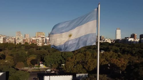 Argentina Flag Waving in the Wind over City