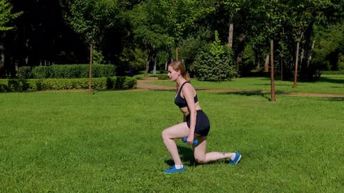 Side View of Active Sporty Fit Woman Doing Dumbbell Reverse Lunges Exercise