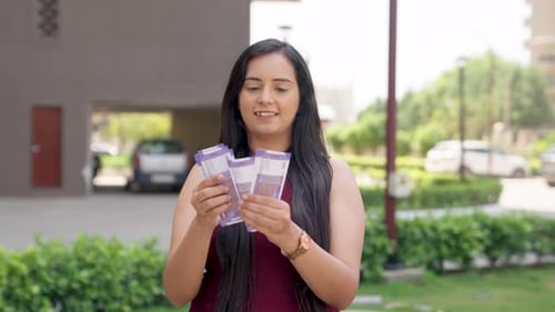 Woman Counting Money Outdoors in Suburban Setting